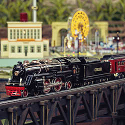 An electric toy train winds around a miniature town. 