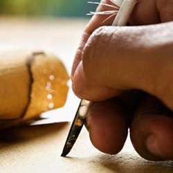 A writer writing with a quill.