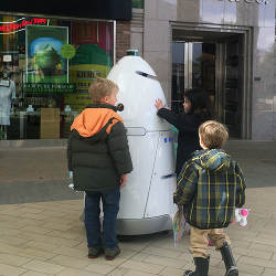 Children approach a K5 robot assigned to security patrol at the Stanford Shopping Center in Palo Alto, CA.