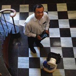 University of Maryland professor Vikrant Aute stands next to the prototype RoCo personal air-conditioning robot.