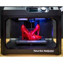 A consumer three-dimensional printer in use. 