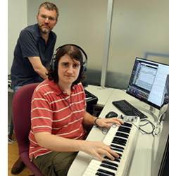 Andrew Garner (seated) and Vlatko Vedral with a computer and keyboard set-up that translates quantum effects into musical sounds.