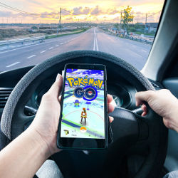 driver playing Pokmon Go