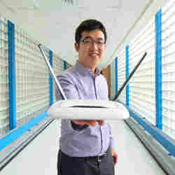 MSU assistant professor of electrical and computer engineering Mi Zhang holds a router. 