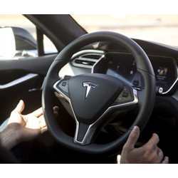 A driver takes his hands off the steering wheel.