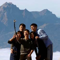 A group of tourists take a selfie on the peak of Mount Rigi, Switzerland.
