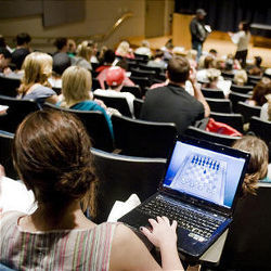 student with laptop in classroom