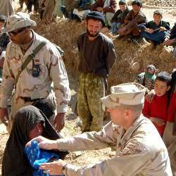 U.S. Army soldiers interacting with locals in Afghanistan.