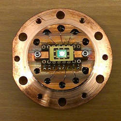 The microchannel device on a copper sample cell.