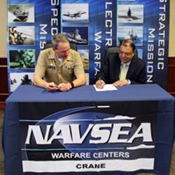 Signing an agreement to improve military sensor technology.