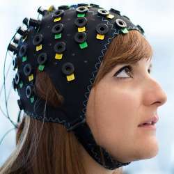 A model displays the NIRS/EEG brain-computer interface system.