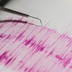 Charting tremors via seismograph.