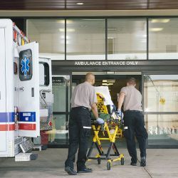 patient on stretcher led to emergency room entrance