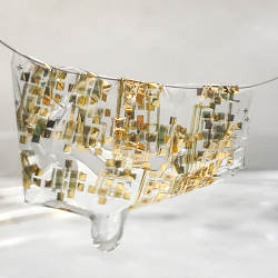 The new flexible, biodegradable semiconductor shown on a human hair.