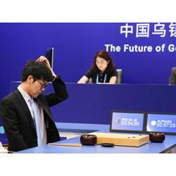 Ke Jie, the worlds top Go player, scratches his head during his match on Tuesday against the AlphaGo artificial intelligence software.