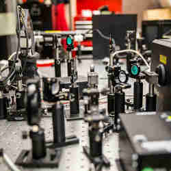 The ultrafast laser shoots very short light pulses 80 million times a second at the hybrid perovskite material.