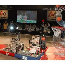 Student-controlled robots compete at the FIRST Robotics Competition by shooting foam basketballs into hoops.