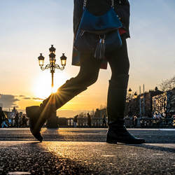 A pedestrian walks across OConnell Bridge in Dublin, Ireland.