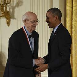 U.S. President Barack Obama congratulating Charles Bachman on his National Medal of Technology and Innovation in 2014. 