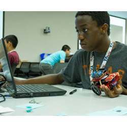 A student at the Code @ TACC Robotics camp programs an Internet-connected robotic car.