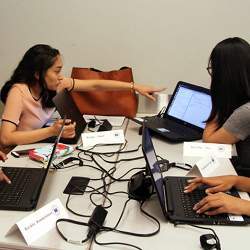 Young women assess a program at a cybersecurity camp held by the New York University Tandon School of Engineering.