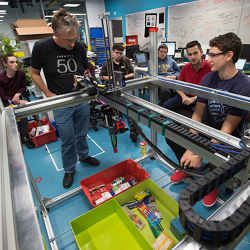 Peter Corke, director of the Australian Center for Robotic Vision at Queensland University of Technology, and other members of Team ACRV work on their robot.