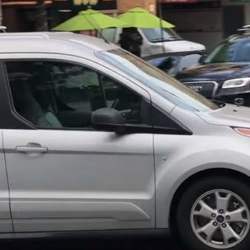 An apparently driverless car, driven by a researcher disguised as a car seat.