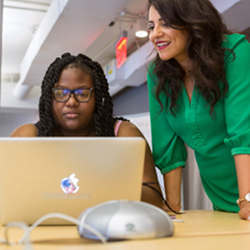 Girls Who Code CEO Reshma Saujani, right, working with a student at the Summer Immersion Program. Credit 