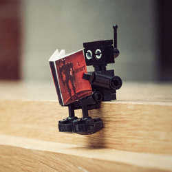 A robot reading a book.