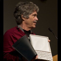 Alan Kay holding Dynabook prototype