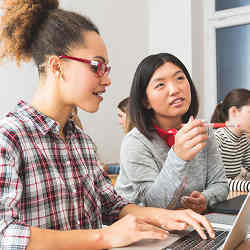 Girls using a computer in class.