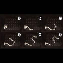 A blob of liquid metal morphs into the letter S using programmable electrical charges.