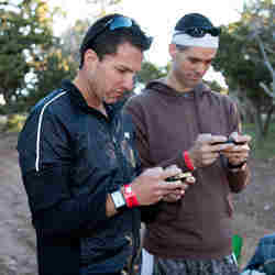 Two hikers focus on the cognitive tests as part of the Rim-to-Rim Wearables study 