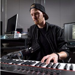 Jason Barnes playing piano with prosthetic hand