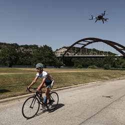 A drone learns from a bicyclist.