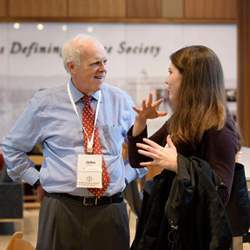 John Hennessy speaking with a student.