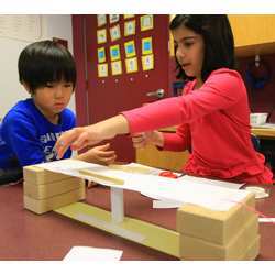 A young girl and boy learning basic concepts in engineering.