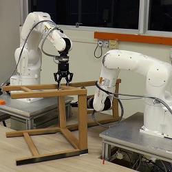 Robot arms assembling a chair.