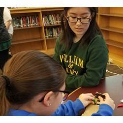 Society of Women in Computing member Linda Wu helps a Berkeley Middle School student build an autopilot program for her handmade car. 