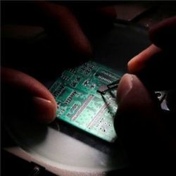 Researcher planting a semiconductor on interface board
