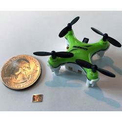 The new computer chip (shown here with a quarter for scale) helps miniature drones navigate in flight.
