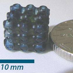 This blue cube of three-dimensionally printed material contains photochromic molecules.