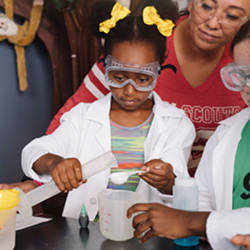 A Girl Scout performing an experiment.