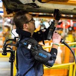 A Ford factory worker wearing the EksoVest exoskeleton.