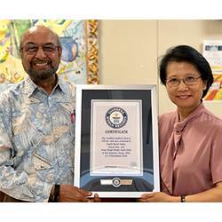 University of Texas at San Antonio professors Amar Balla (left) and Ruyan Guo hold up the certificate from Guiness World Records.