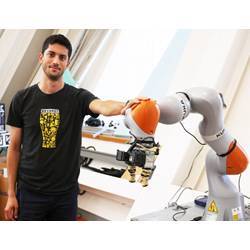 Ph.D. student Lucas Manuelli with a Kuka robot.