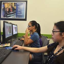 Young women learning to build a game.