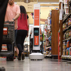 A robot scans shelves in a Schnucks store to flag when items are out of stock.