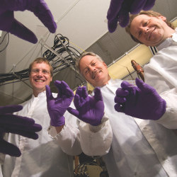 Chris Tasker, John Wager, And Douglas Keszler holding transparent transistors