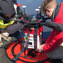 Researchers attach a cooler containing a kidney to a DJI M600 Pro drone.